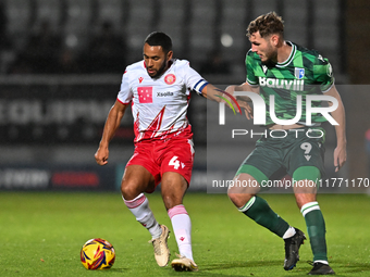 Nathan Thompson (4, Stevenage) is challenged by Josh Andrews (9, Gillingham) during the EFL Trophy match between Stevenage and Gillingham at...