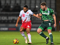 Nathan Thompson (4, Stevenage) is challenged by Josh Andrews (9, Gillingham) during the EFL Trophy match between Stevenage and Gillingham at...