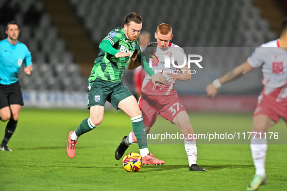 Jack Nolan (7 Gillingham) is challenged by Laurie Walker (37 Stevenage) during the EFL Trophy match between Stevenage and Gillingham at the...