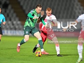 Jack Nolan (7 Gillingham) is challenged by Laurie Walker (37 Stevenage) during the EFL Trophy match between Stevenage and Gillingham at the...