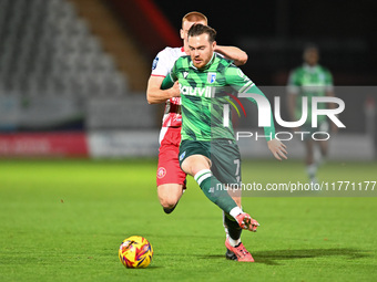 Jack Nolan (7 Gillingham) is challenged by Laurie Walker (37 Stevenage) during the EFL Trophy match between Stevenage and Gillingham at the...