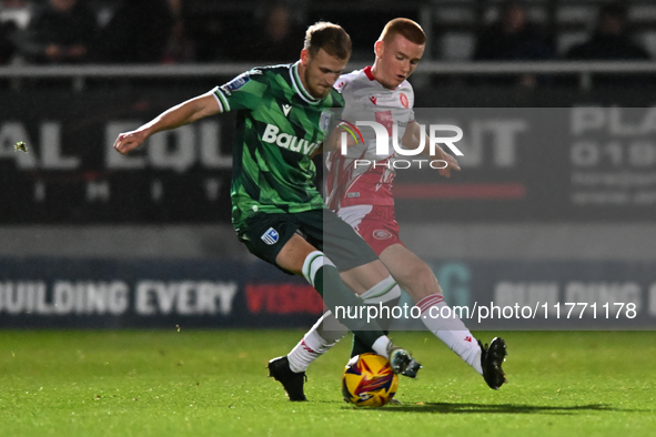 Nick Freeman (7, Stevenage) challenges Ethan Coleman (6, Gillingham) during the EFL Trophy match between Stevenage and Gillingham at the Lam...