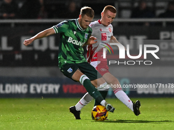 Nick Freeman (7, Stevenage) challenges Ethan Coleman (6, Gillingham) during the EFL Trophy match between Stevenage and Gillingham at the Lam...