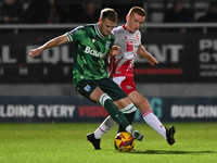 Nick Freeman (7, Stevenage) challenges Ethan Coleman (6, Gillingham) during the EFL Trophy match between Stevenage and Gillingham at the Lam...