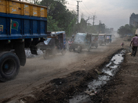 People move through a dusty, busy road in Dhaka, Bangladesh, on November 12, 2024. Dhaka, the overcrowded capital city, ranks 17th among cit...