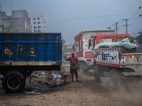 People move through a dusty, busy road in Dhaka, Bangladesh, on November 12, 2024. Dhaka, the overcrowded capital city, ranks 17th among cit...