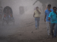 People move through a dusty, busy road in Dhaka, Bangladesh, on November 12, 2024. Dhaka, the overcrowded capital city, ranks 17th among cit...