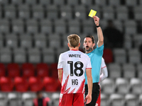 Harvey White, 18, from Stevenage, receives a yellow card during the EFL Trophy match between Stevenage and Gillingham at the Lamex Stadium i...