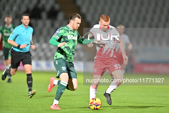 Jack Nolan (7 Gillingham) challenges Laurie Walker (37 Stevenage) during the EFL Trophy match between Stevenage and Gillingham at the Lamex...