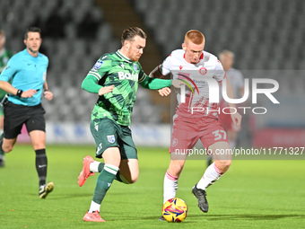 Jack Nolan (7 Gillingham) challenges Laurie Walker (37 Stevenage) during the EFL Trophy match between Stevenage and Gillingham at the Lamex...