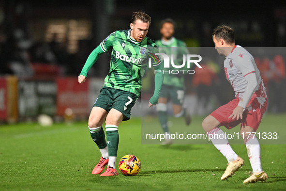 Jack Nolan (7 Gillingham) is challenged by Kane Smith (14 Stevenage) during the EFL Trophy match between Stevenage and Gillingham at the Lam...