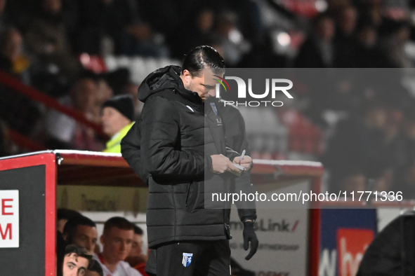 Manager Mark Bonner of Gillingham makes notes during the EFL Trophy match between Stevenage and Gillingham at the Lamex Stadium in Stevenage...