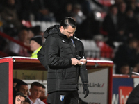 Manager Mark Bonner of Gillingham makes notes during the EFL Trophy match between Stevenage and Gillingham at the Lamex Stadium in Stevenage...