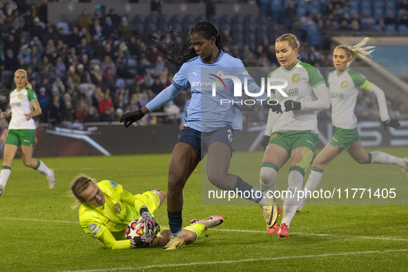 Anna Tamminen #1 (GK) of Hammarby IF makes a save from Khadija Shaw #21 of Manchester City W.F.C. during the UEFA Champions League Group D m...