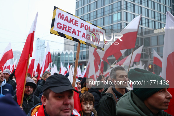 Participant carry flags while attending Independence March celebrating the 106 anniversary of Poland regaining independence. Warsaw, Poland...