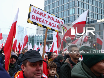 Participant carry flags while attending Independence March celebrating the 106 anniversary of Poland regaining independence. Warsaw, Poland...