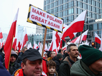 Participant carry flags while attending Independence March celebrating the 106 anniversary of Poland regaining independence. Warsaw, Poland...