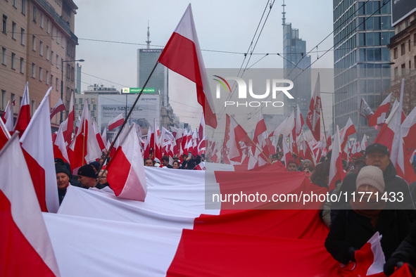 Participant carry flags while attending Independence March celebrating the 106 anniversary of Poland regaining independence. Warsaw, Poland...