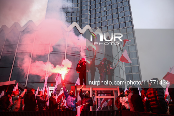 Participant hold flags and flares while attending Independence March celebrating the 106 anniversary of Poland regaining independence. Warsa...