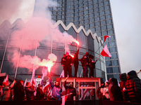 Participant hold flags and flares while attending Independence March celebrating the 106 anniversary of Poland regaining independence. Warsa...