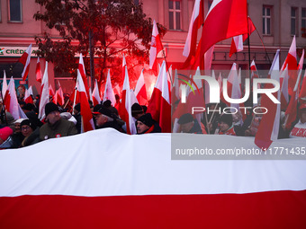 Participant carry flags while attending Independence March celebrating the 106 anniversary of Poland regaining independence. Warsaw, Poland...