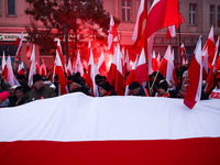 Participant carry flags while attending Independence March celebrating the 106 anniversary of Poland regaining independence. Warsaw, Poland...