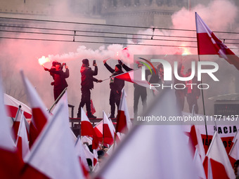 Participant hold flags and flares while attending Independence March celebrating the 106 anniversary of Poland regaining independence. Warsa...