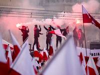 Participant hold flags and flares while attending Independence March celebrating the 106 anniversary of Poland regaining independence. Warsa...