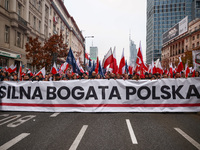 Participants carry a banner reading 'Storng Wealthy Poland' while attending Independence March celebrating the 106 anniversary of Poland reg...