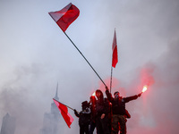 Participant hold flags and flares while attending Independence March celebrating the 106 anniversary of Poland regaining independence. Warsa...