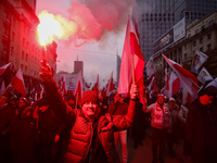 Participant hold flags and flares while attending Independence March celebrating the 106 anniversary of Poland regaining independence. Warsa...