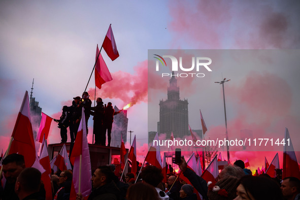 Participant hold flags and flares while attending Independence March celebrating the 106 anniversary of Poland regaining independence. Warsa...