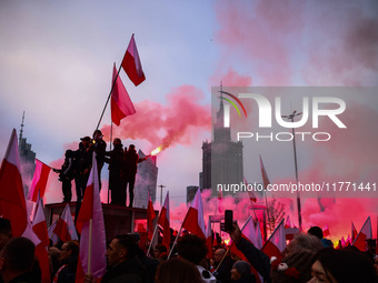 Participant hold flags and flares while attending Independence March celebrating the 106 anniversary of Poland regaining independence. Warsa...