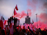 Participant hold flags and flares while attending Independence March celebrating the 106 anniversary of Poland regaining independence. Warsa...