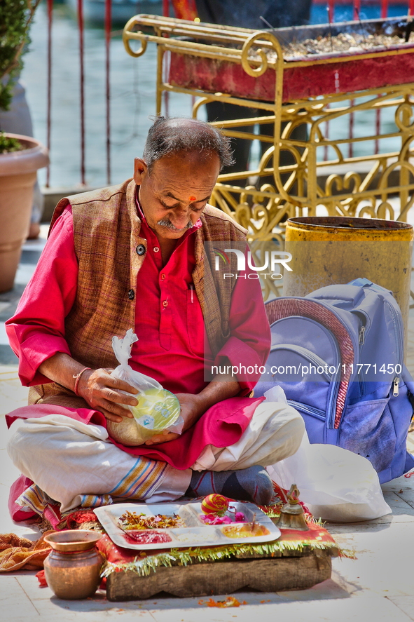 A Hindu priest waits to bless devotees at the Maa Naina Devi Temple in Nainital, Uttarakhand, India, on April 21, 2024. Naina Devi Temple is...