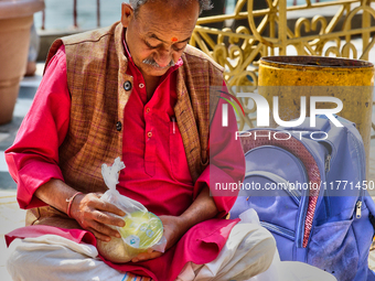 A Hindu priest waits to bless devotees at the Maa Naina Devi Temple in Nainital, Uttarakhand, India, on April 21, 2024. Naina Devi Temple is...