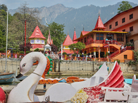 Swan-shaped paddle boats are seen along Naini Lake by the Maa Naina Devi Temple in Nainital, Uttarakhand, India, on April 21, 2024. Naina De...