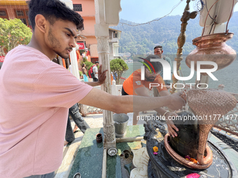 Hindu devotees offer prayers to Lord Shiva at the Maa Naina Devi Temple in Nainital, Uttarakhand, India, on April 21, 2024. Naina Devi Templ...