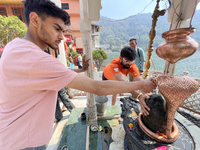 Hindu devotees offer prayers to Lord Shiva at the Maa Naina Devi Temple in Nainital, Uttarakhand, India, on April 21, 2024. Naina Devi Templ...