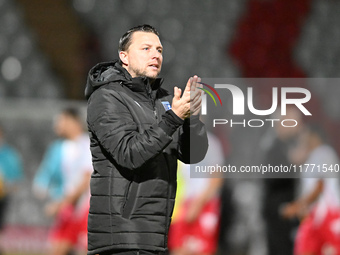 Manager Mark Bonner, the manager of Gillingham, applauds fans after the final whistle during the EFL Trophy match between Stevenage and Gill...