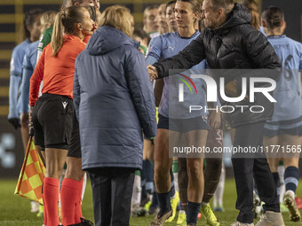 Hammarby IF manager Martin Sjogren shakes hands with Referee Frida Nielsen at full time during the UEFA Champions League Group D match betwe...