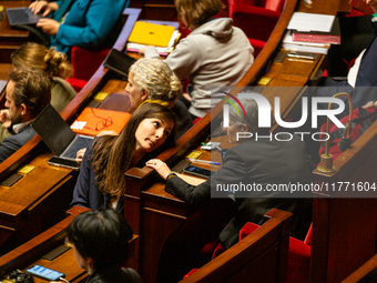 Sandrina Rousseau (R) and Marie-Charlotte Garin (L), MPs deputies of the Ecologiste et Social group, are seen during the public session of t...