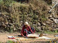 A farmer dries crops on the sunshade in the village of Makwanpur, Nepal, on November 12, 2024. (