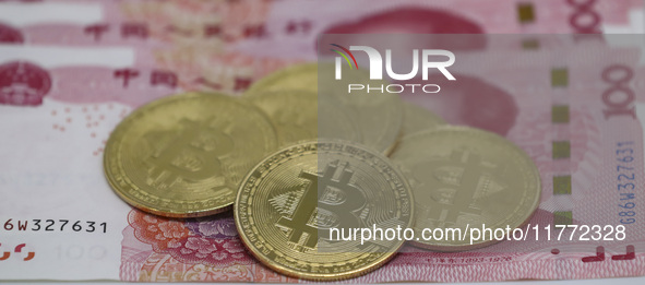 A photo taken in Huaian, China, on November 13, 2024, shows bitcoin and the Chinese yuan. 