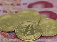 A photo taken in Huaian, China, on November 13, 2024, shows bitcoin and the Chinese yuan. (