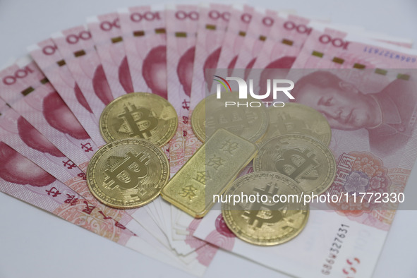 A photo taken in Huaian, China, on November 13, 2024, shows bitcoin and the Chinese yuan. 