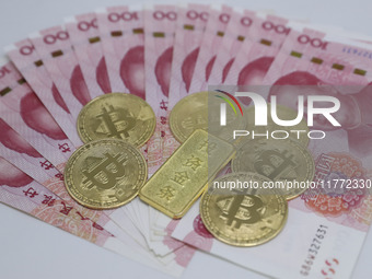 A photo taken in Huaian, China, on November 13, 2024, shows bitcoin and the Chinese yuan. (