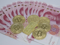 A photo taken in Huaian, China, on November 13, 2024, shows bitcoin and the Chinese yuan. (