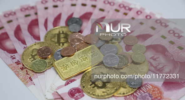 A photo taken in Huaian, China, on November 13, 2024, shows bitcoin and the Chinese yuan. 