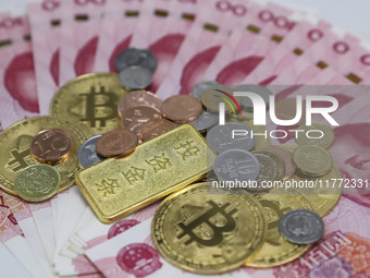 A photo taken in Huaian, China, on November 13, 2024, shows bitcoin and the Chinese yuan. (